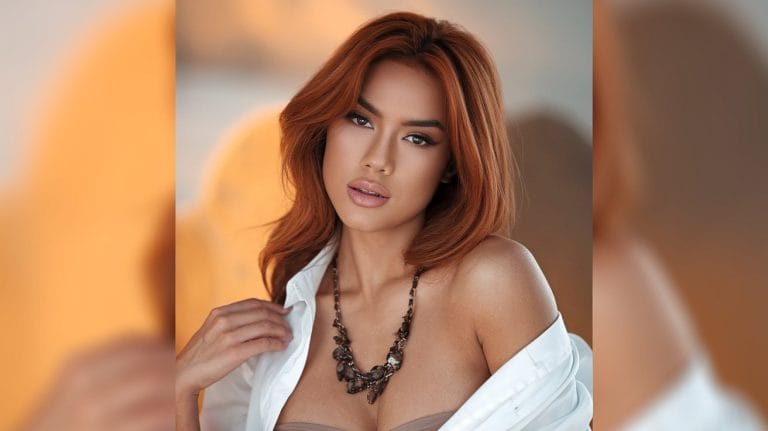 Woman with red hair and necklace posing