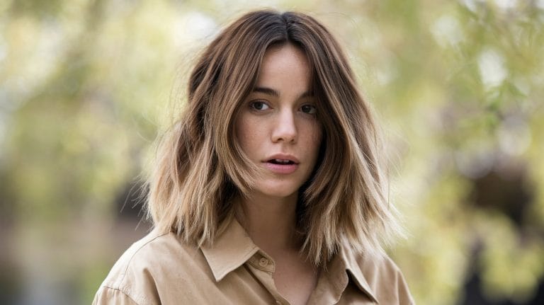 Woman with shoulder-length brown hair outdoors