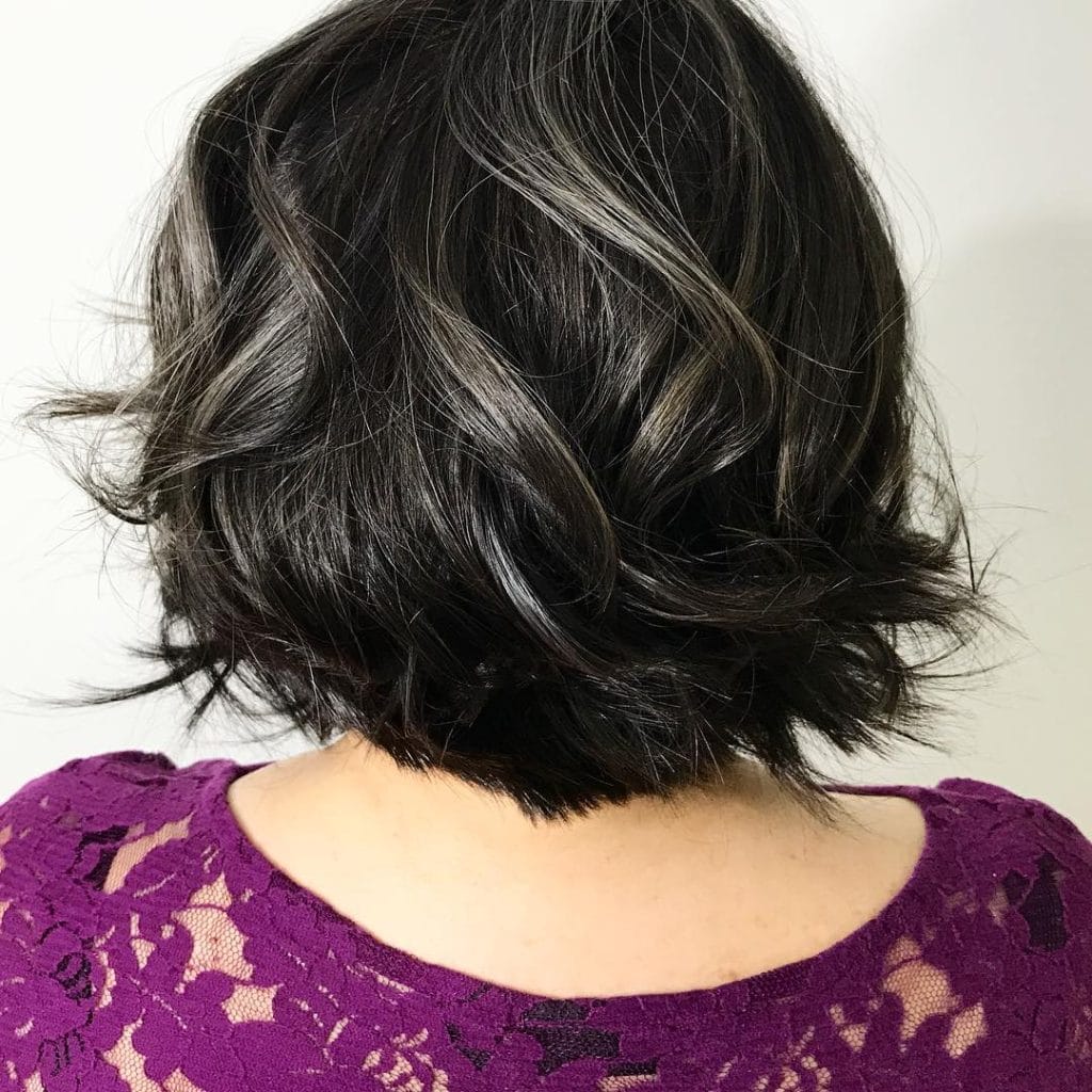 Woman with short, dark hair from the back.