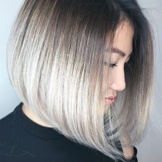Woman with stylish ash blonde bob haircut