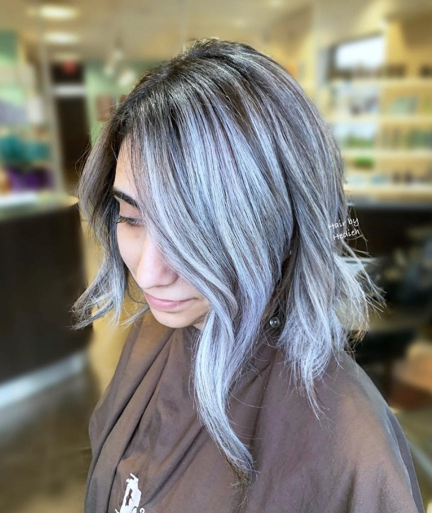 Woman with gray balayage hairstyle in a salon.