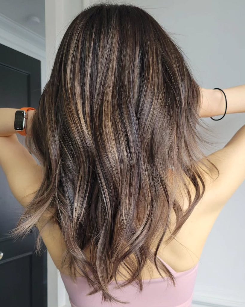 Woman with wavy brown hair from back view