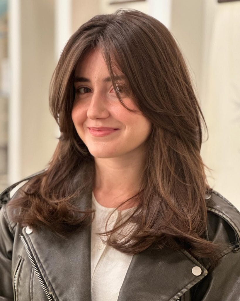 Smiling woman with long brown hair and jacket