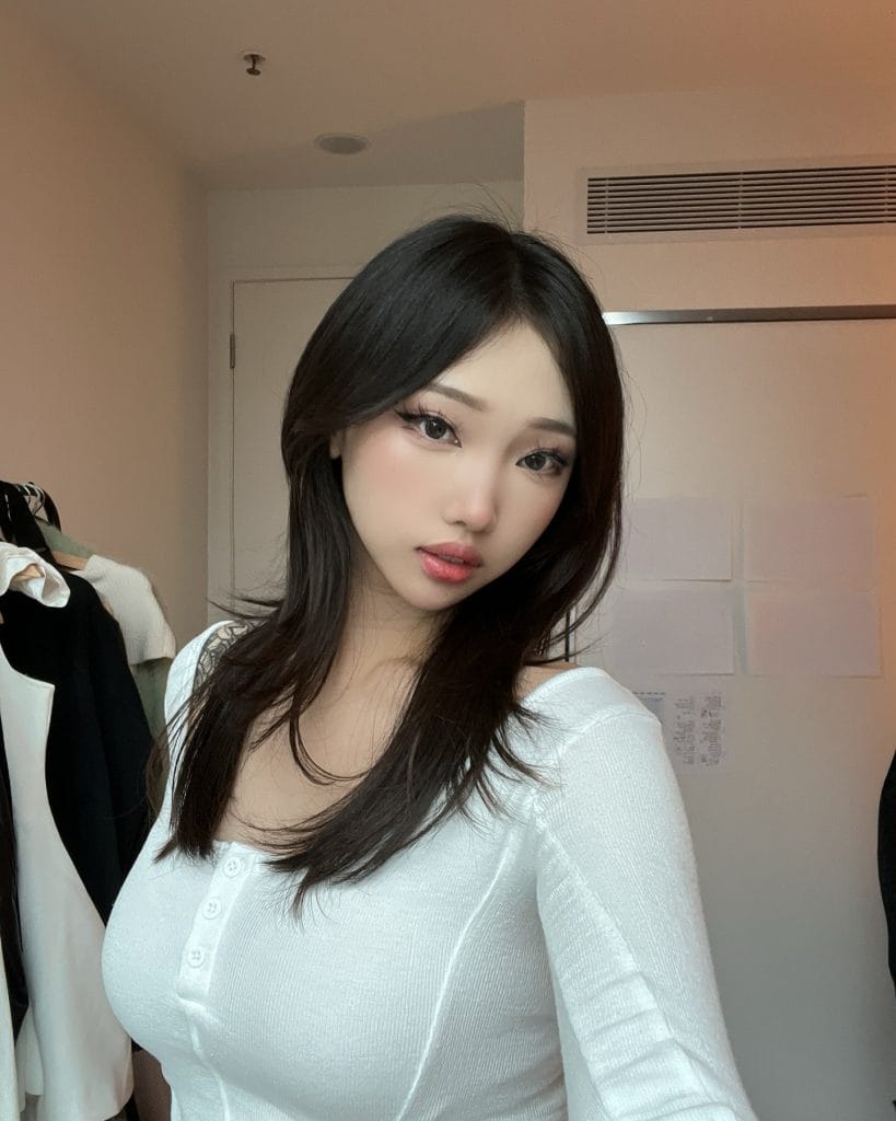 Person in a white top in a room.