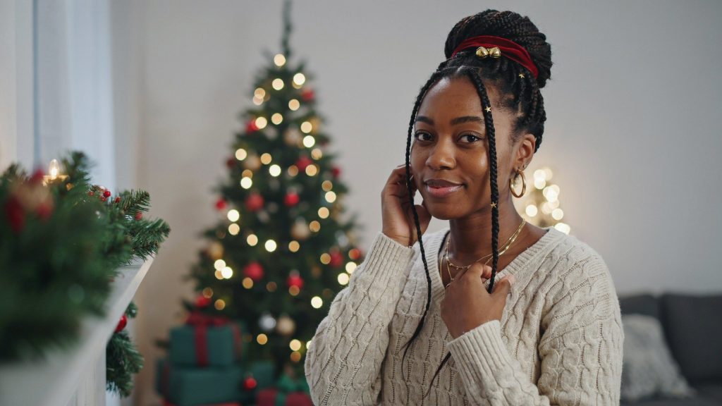 a black women with beautiful styled hair for christmas.